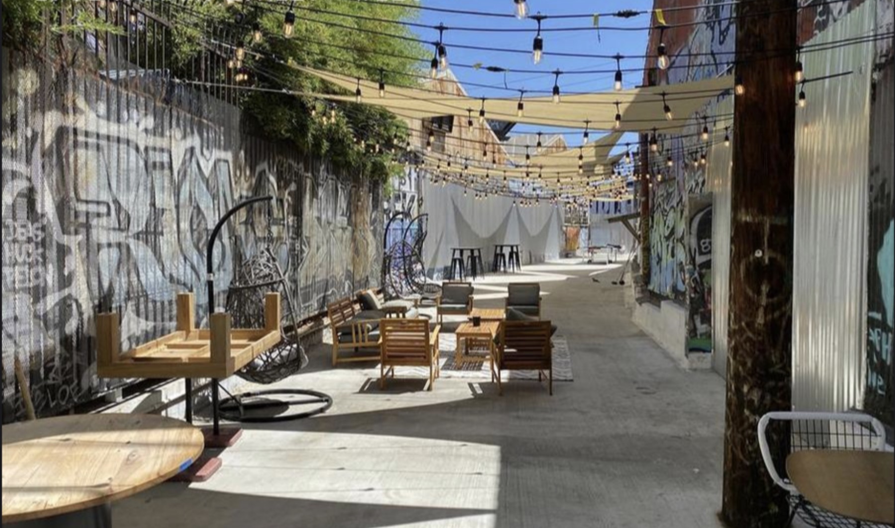 Outdoor patio with string lights and graffiti walls