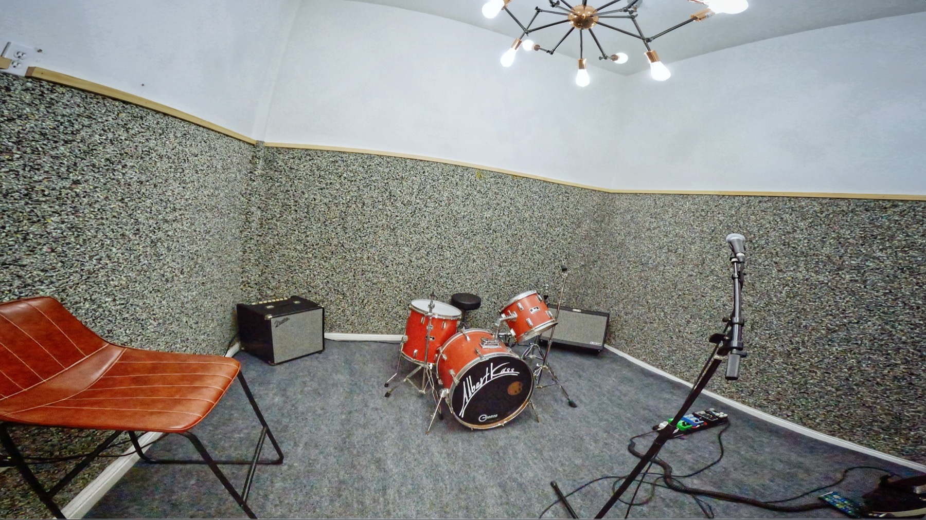 Rehearsal room with drum kit and amps
